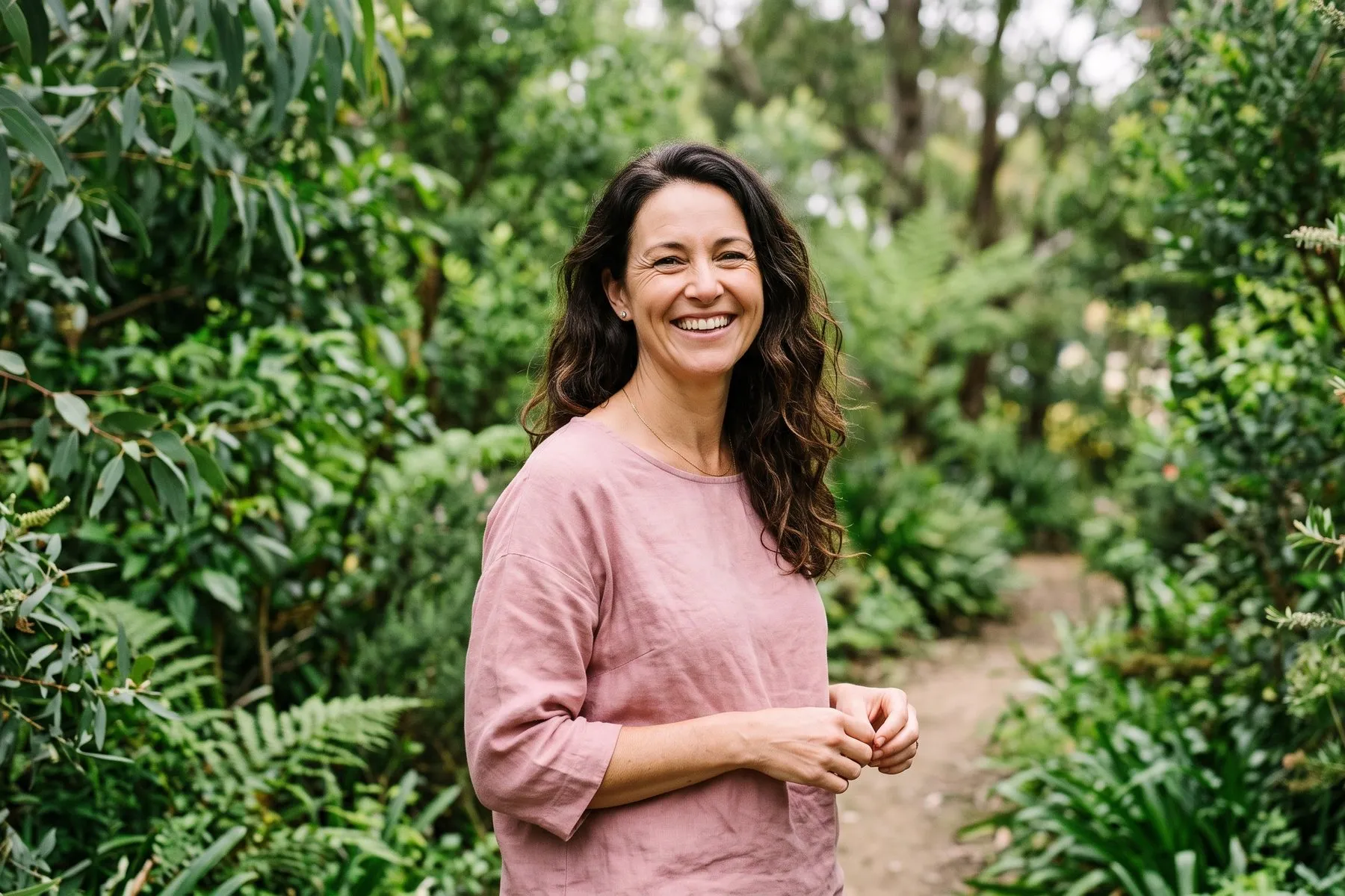 Woman smiling outdoors, living well with less pain
