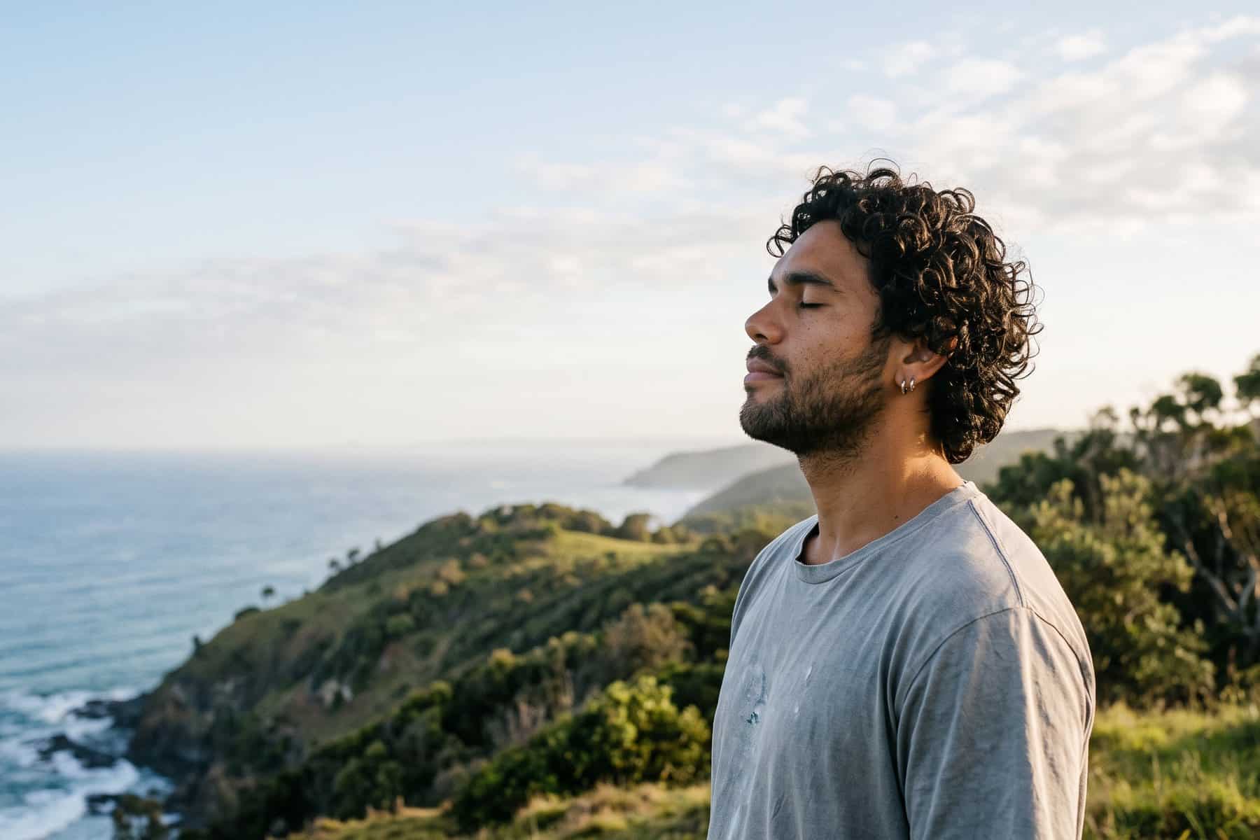 Man with eyes closed breathing calmly in the open air